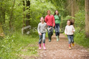 stock-photo-17321874-family-walking-on-path-smiling